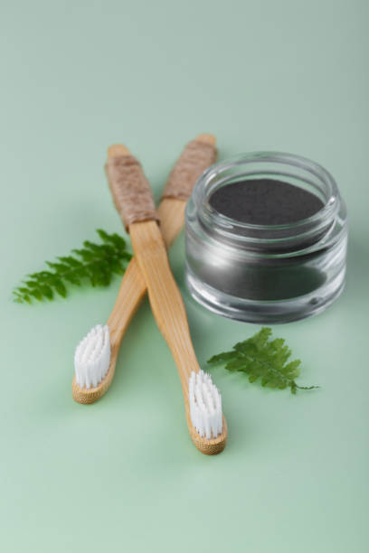 istock Natural bamboo tooth brushes and black dental powder 1250657060