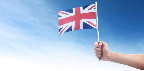 istock Hand holding English flag. flag in hand 1250657266