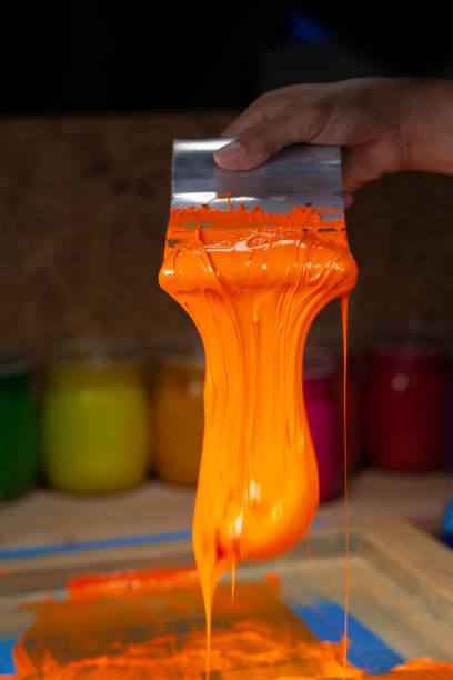 istock orange color dripping from hand screen printing 1250664838