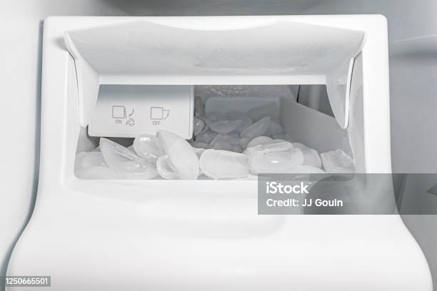 Closeup Of Ice Maker Machine In Refrigerator With Ice Cubes Concept Of Clean Water Filter Household Appliance Repair Maintenance And Service Stock Photo - Download Image Now
