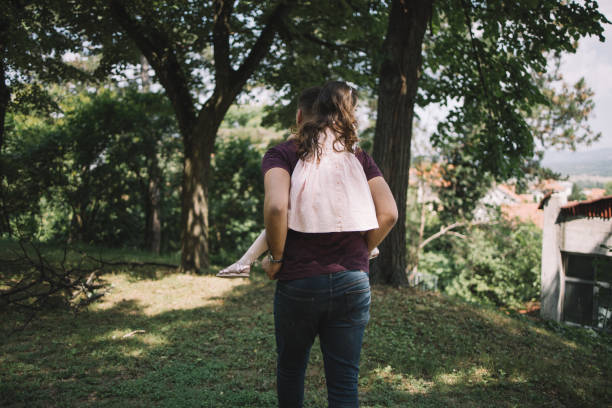 istock Back of father carrying his daughter on back 1250665592