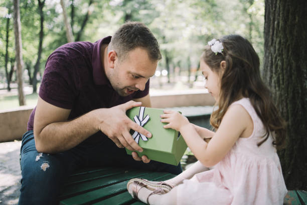 istock Surprised dad and daughter looking in opened gift box 1250665806