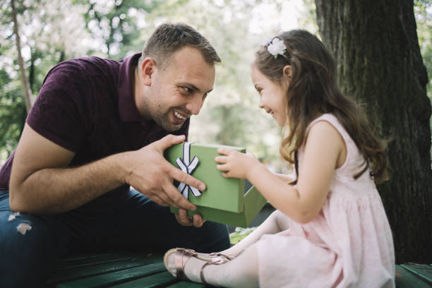 istock Smiling father and daughter looking at each other 1250665822
