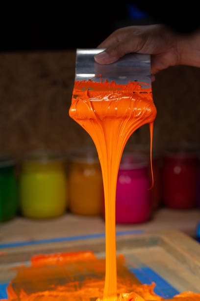 istock orange color dripping from hand screen printing 1250667157