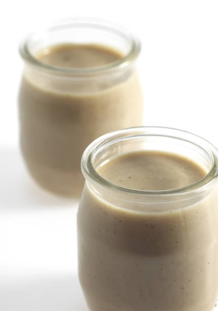 istock Glasses of Hazelnut Cream against White Background 1250668832