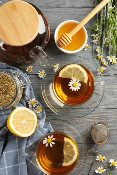 istock Composition with chamomile tea on gray wooden background 1250669075