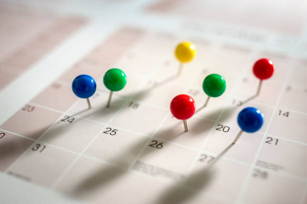Calendar event appointment Thumbtack pins in calendar concept for busy, appointment and meeting reminder calendar date photos stock pictures, royalty-free photos & images