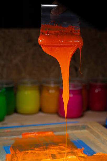 istock orange color dripping from hand screen printing 1250669230