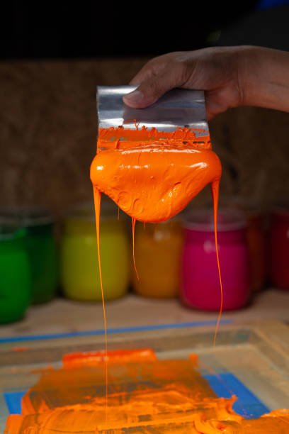istock orange color dripping from hand screen printing 1250670623