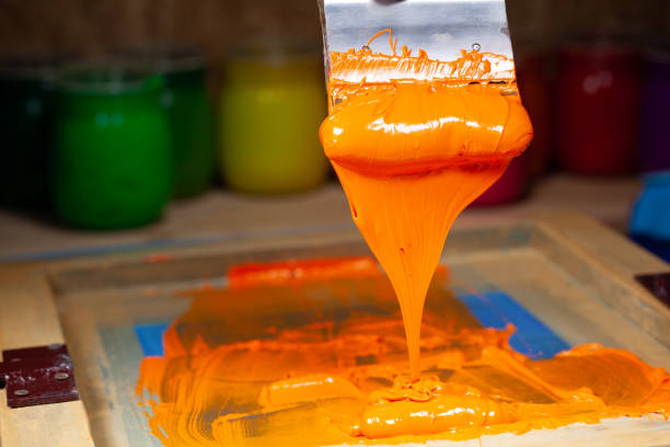 istock orange color dripping from hand screen printing 1250670630
