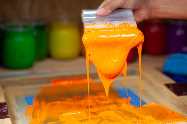 istock orange color dripping from hand screen printing 1250670638