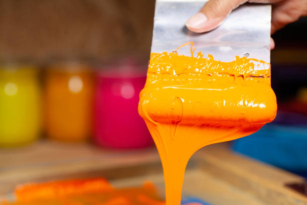 istock orange color dripping from hand screen printing 1250670644