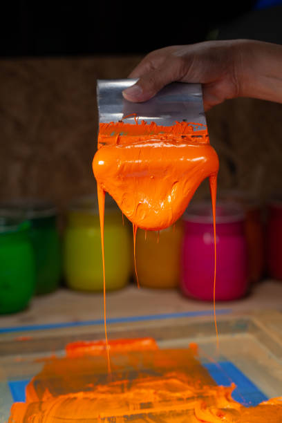 istock orange color dripping from hand screen printing 1250670646