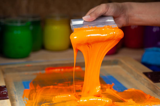istock orange color dripping from hand screen printing 1250670647