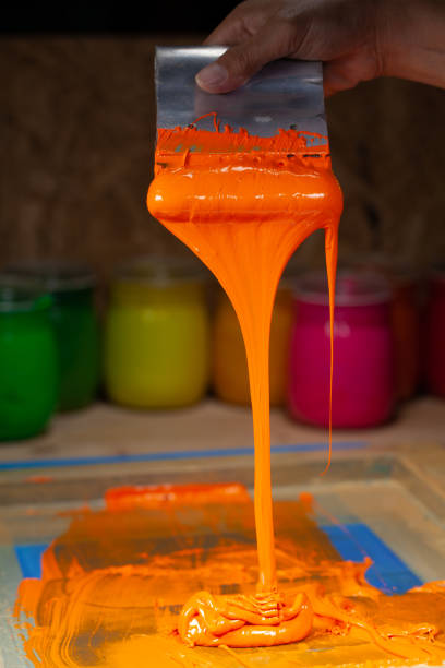 istock orange color dripping from hand screen printing 1250670648