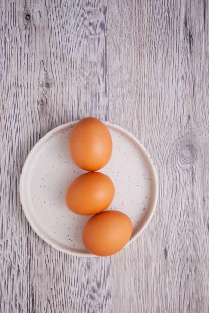 istock Top view of three eggs on a white plate 1250672469