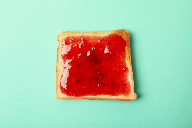 istock Toast with strawberry jam on mint background, top view 1250672554