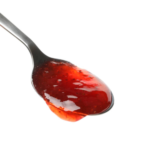 istock Spoon with strawberry jam isolated on white background 1250672603