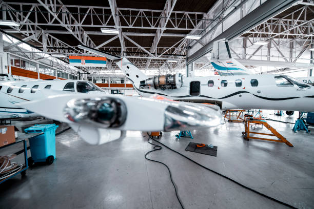 istock Two small private planes in a maintenance hangar 1250672657