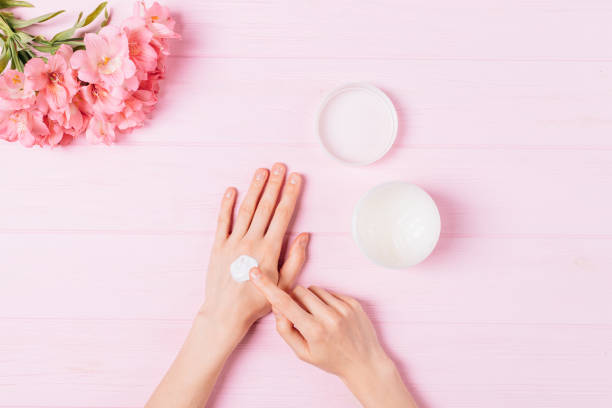 istock Female hands apply cosmetic moisturizer balm 1250674744
