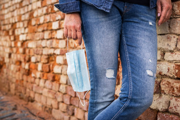 istock Protective face mask in female hand. New normal in city 1250674841