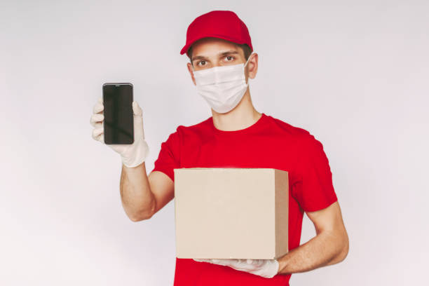 istock Blank empty copy space on smart phone and parcel box in delivery man hands 1250676327