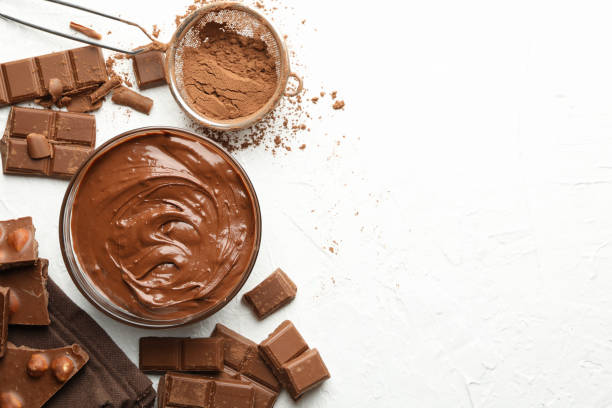 istock Chocolate, melted chocolate and powder on white background 1250676908