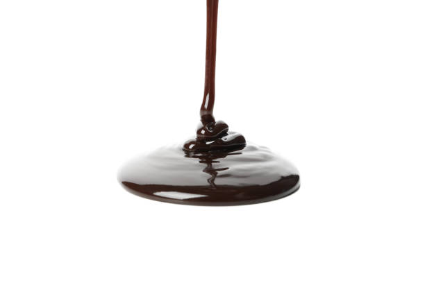 istock Melted chocolate is pouring, isolated on white background 1250677101