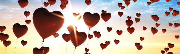 istock Many Balloons Flying to the blue sky with sunlight 1250680610