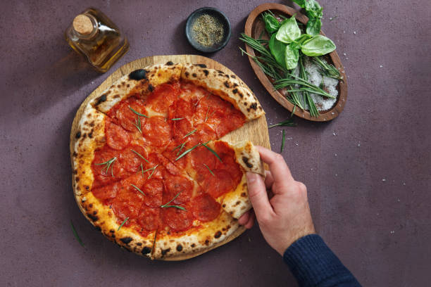 istock Man Eating Pepperoni Pizza Slice 1250681585