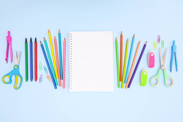 istock Back to school concept on blue background. School supplies and open notebook on pastel blue background 1250682043