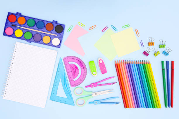 istock Back to school concept on blue background. School supplies and open notebook on pastel blue background 1250682323
