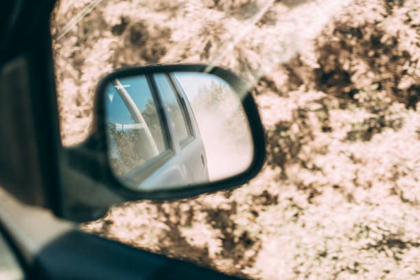 istock Dirty Road View From Rearview Mirror 1250683332