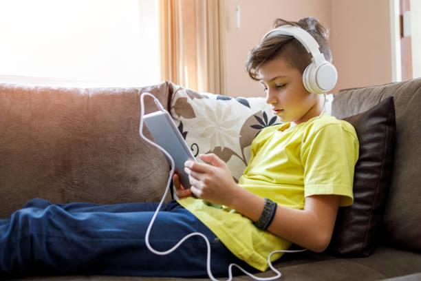istock Kid listening music via digital tablet 1250685660