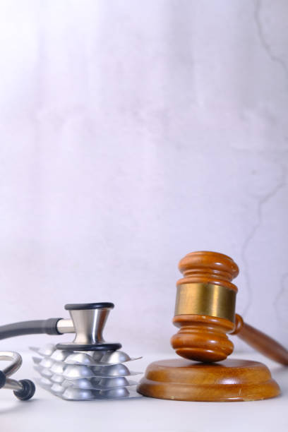 istock gavel, stethoscope and pills on white background 1250687147