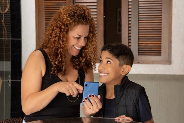 istock mother and son at home watching content on cell phone 1250688442