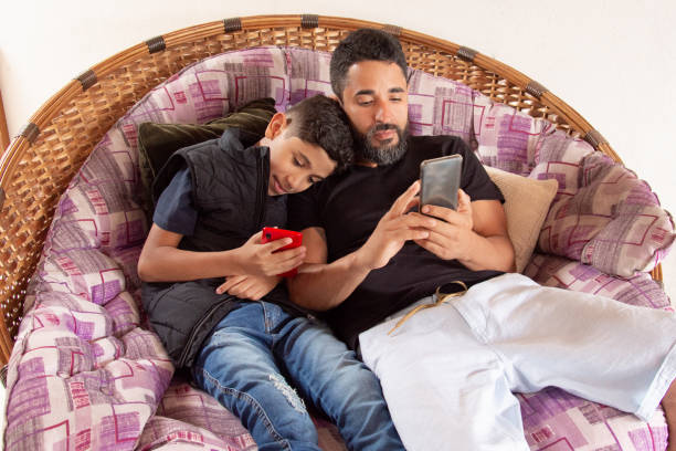 istock father and son looking at cellphone together 1250688621