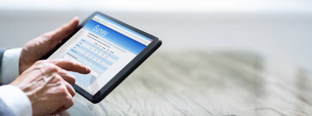 istock Man Filling Online Survey Form On Digital Tablet 1250688804