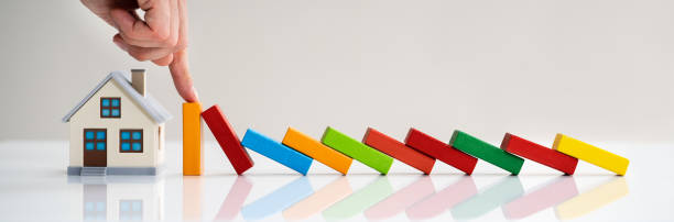 istock Hand Stopping Domino To Protect Home 1250689375