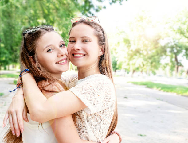 istock Happy girlfriends hugging together outdoors 1250695360