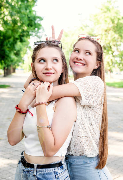 istock Happy girlfriends hugging together outdoors 1250695515