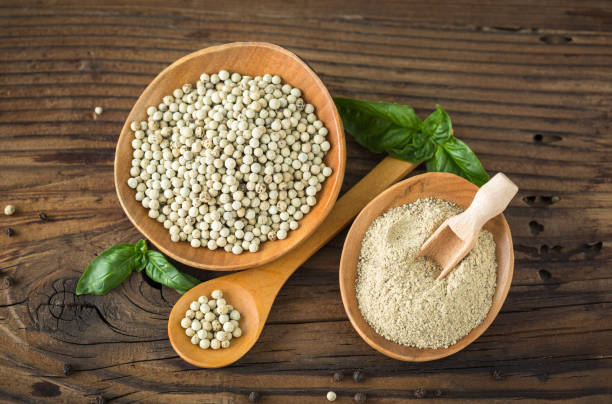 White pepper in the wooden bowl stock photo