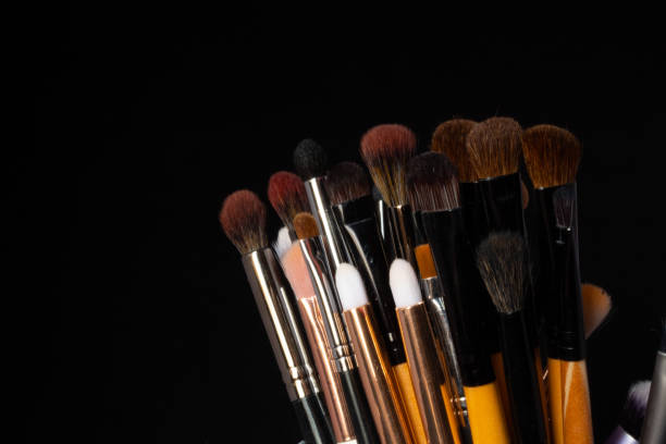 istock many makeup brushes of various colors, on a black background 1250702039
