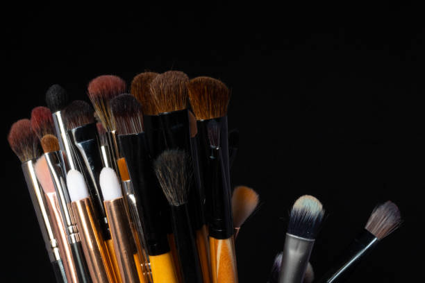 istock many makeup brushes of various colors, on a black background 1250702048