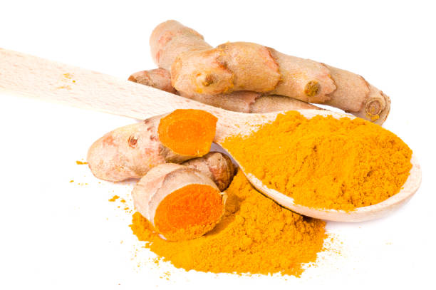 istock Turmeric powder with turmeric root isolated on white background 1250705126