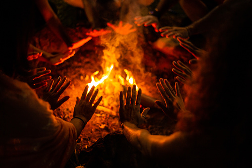 Ritual around the campfire. Bonfire flames on pieces of firewood.