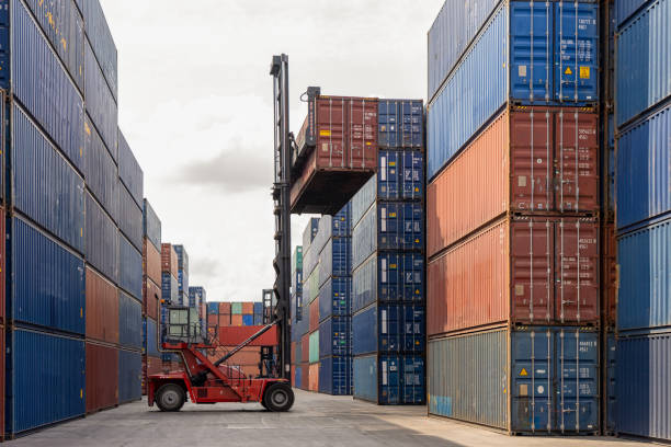 istock Folk lift car working in container yard for preparing imported or exported products background,Container Trainer full of products for delivery to customer 1250707629