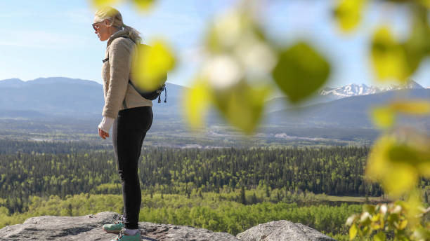 istock Female hiker relaxes on mountain ridge 1250708214