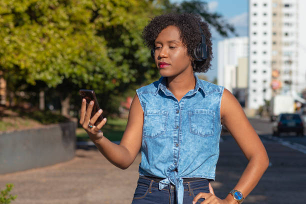 istock Young listening to music during walk 1250713071