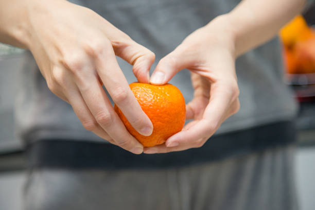 istock female hands clean mandarin 1250713539